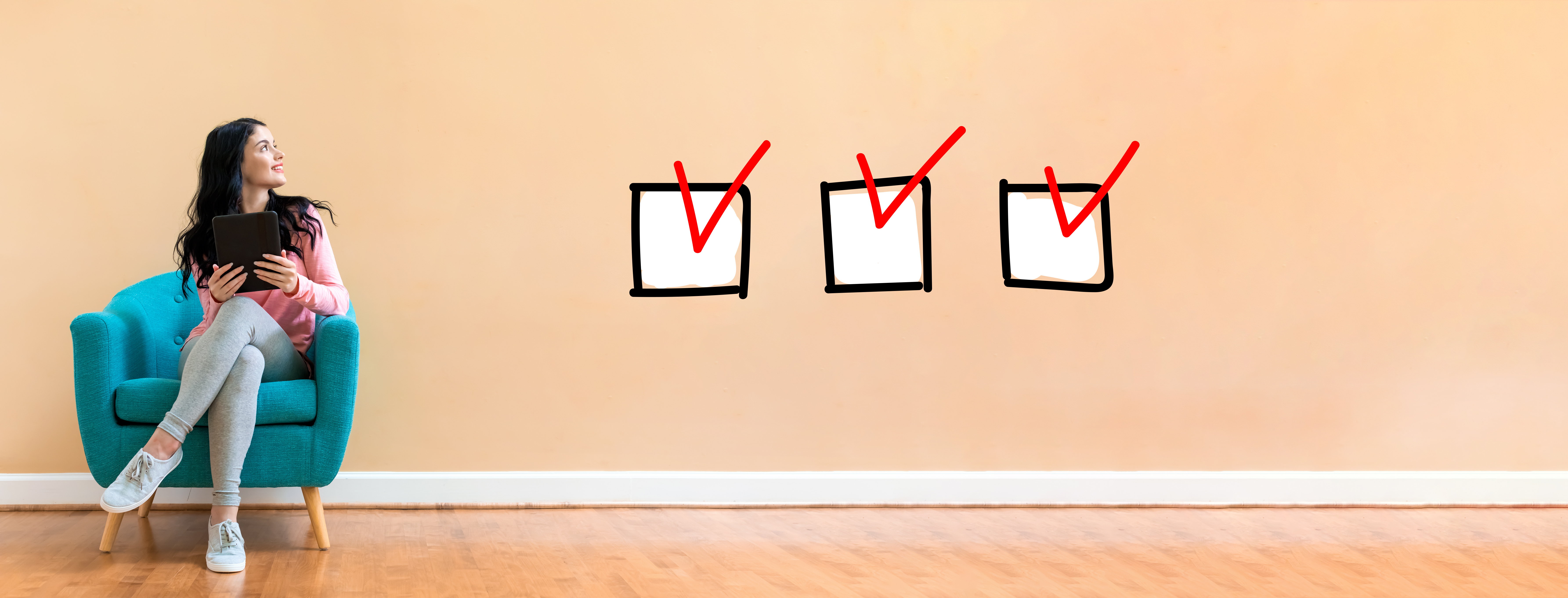 Woman sitting in a chair with checkboxes floating nearby.