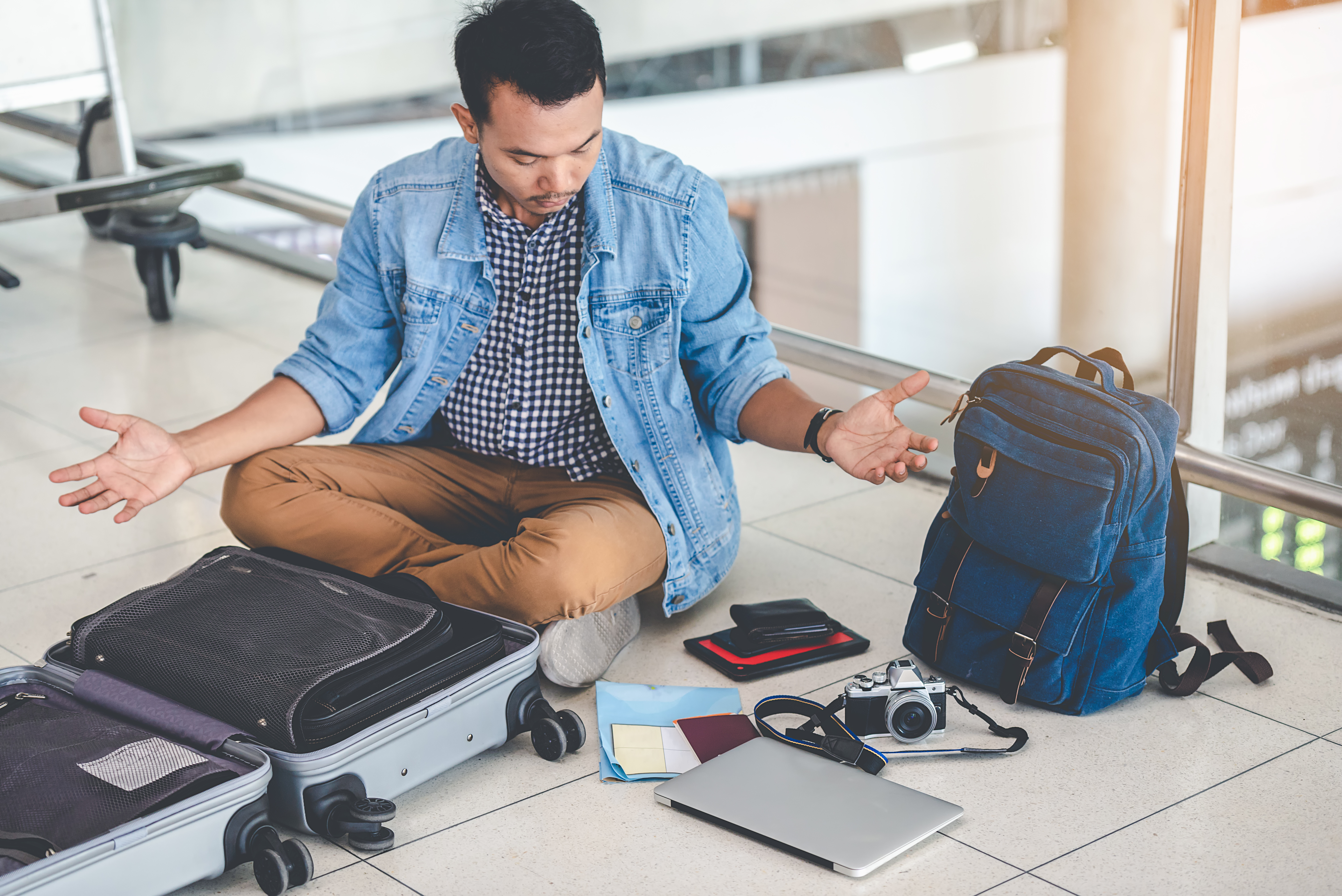 Person on the floor looking through the items in their bag