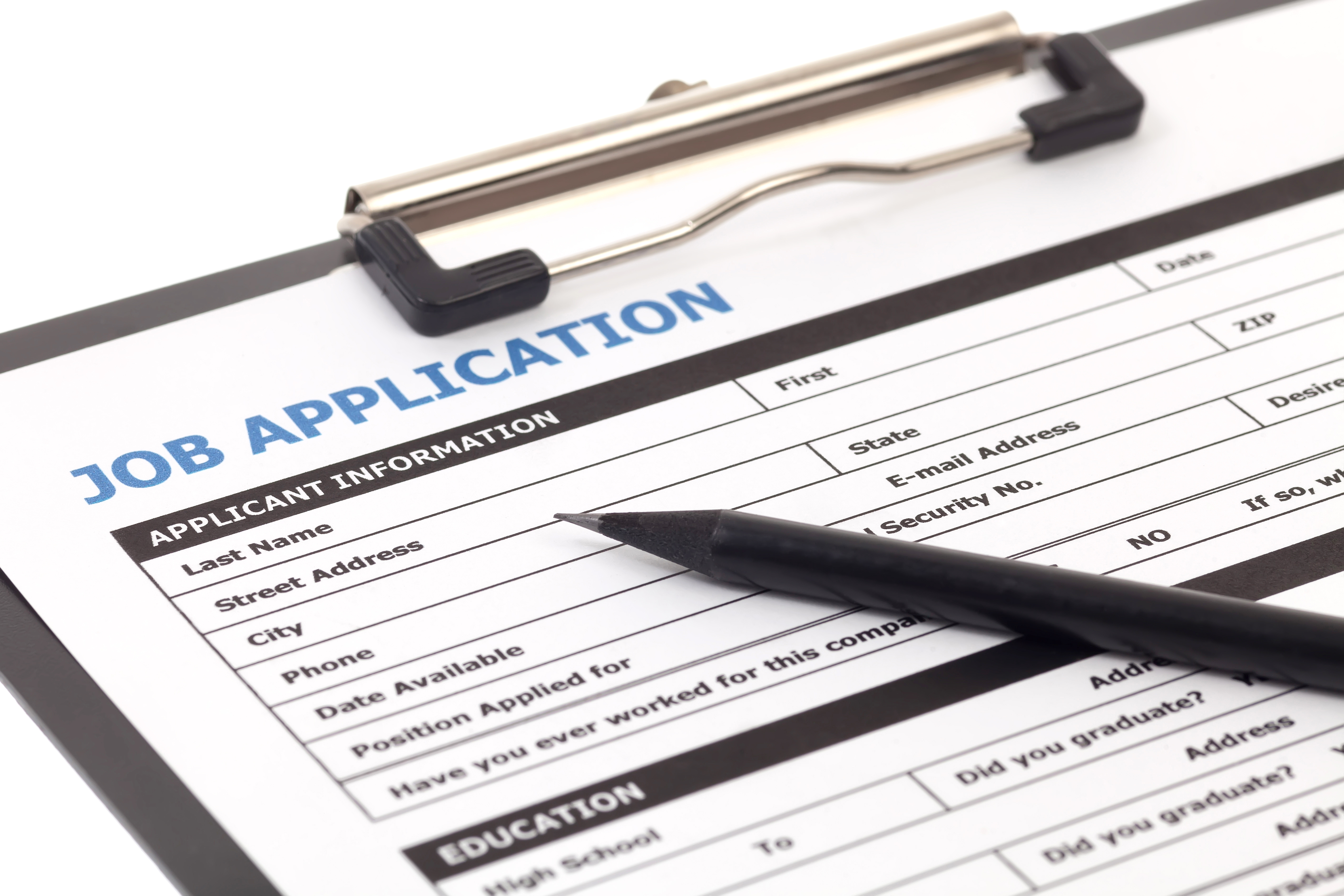 Picture of a paper job application with a pen laid across it.